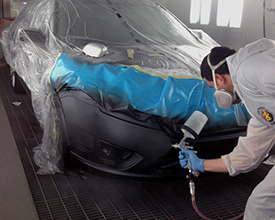 Man Spray Painting Car